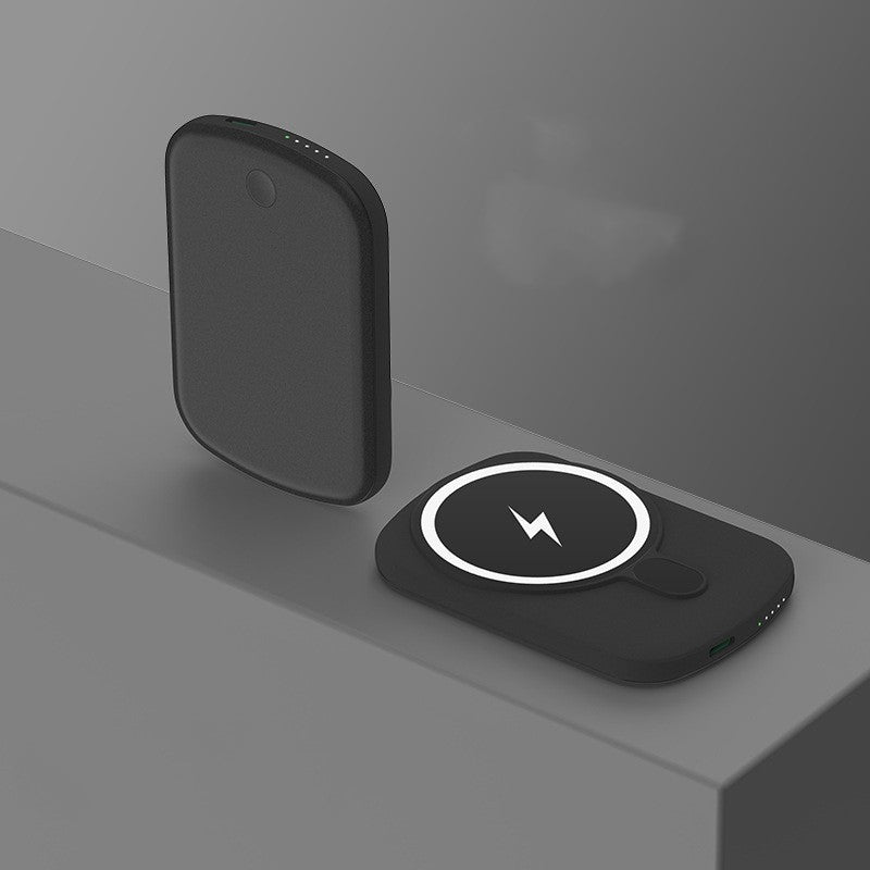Black wireless charging pad with lightning bolt symbol on a gray surface