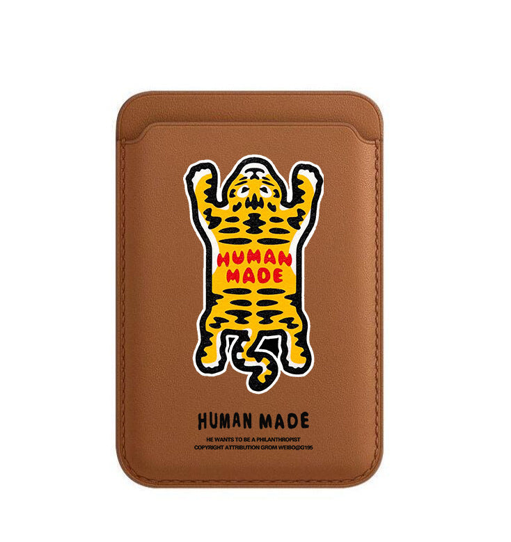 Brown leather cardholder with a tiger illustration and 'Human Made' text on a white background
