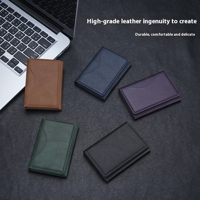 Five leather wallets in different colors on a dark surface with a laptop.