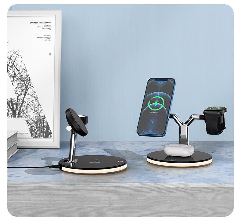 Multi-device charging stand with smartphone, smartwatch, and wireless chargers on a desk.