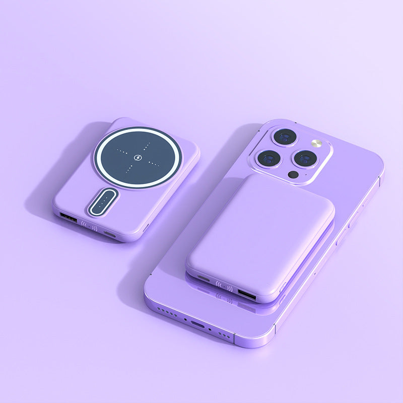 Purple smartphone and wireless charging pad on a light purple background