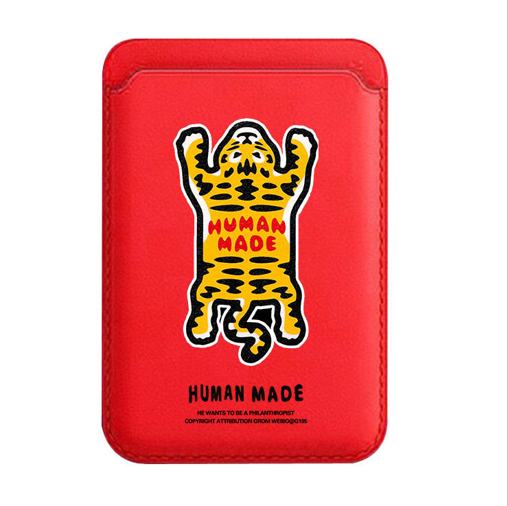 Red phone case with a yellow and black graphic of a bear and 'Human Made' branding on a white background.