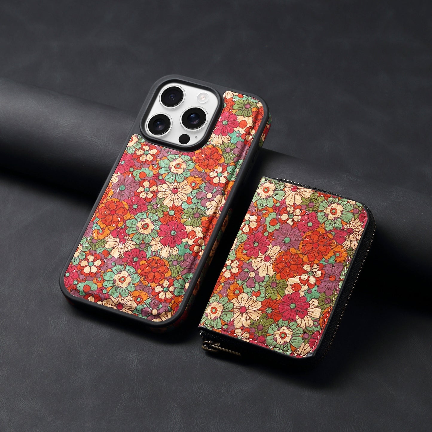 Floral patterned phone case with a matching wallet on a dark background