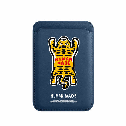 Navy blue cardholder with a yellow and black panther graphic and 'Human Made' text on a white background