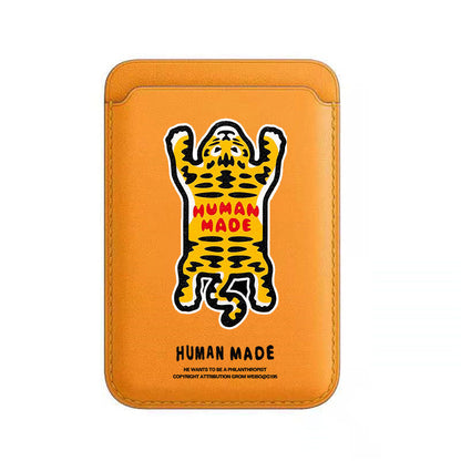 Orange phone case with a leopard graphic and 'Human Made' text on a white background