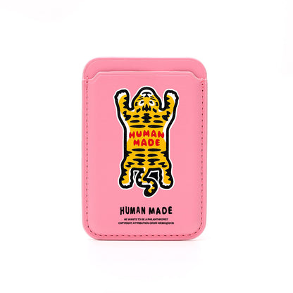 Pink cardholder with a tiger illustration and 'Human Made' branding on a white background