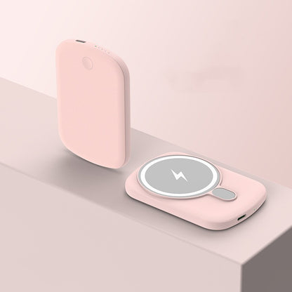 Pink wireless charging pad on a light pink background