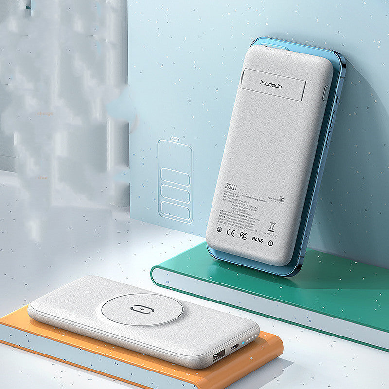 Two power banks on a light blue surface with a wooden block